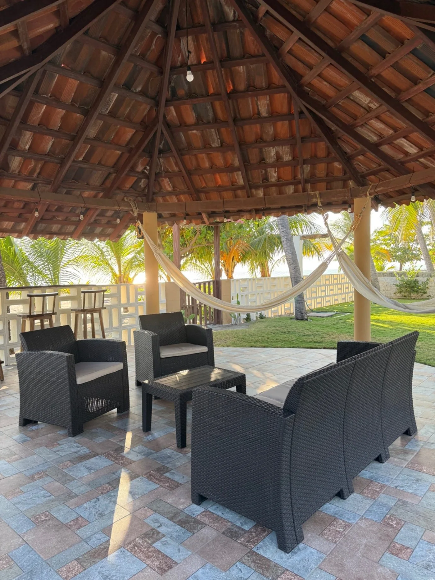Palapa de Rancho Palmar con hamacas y sala exterior rodeada de jardín